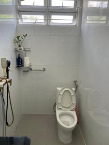 a bathroom with a toilet with the lid up at Beachside home in Phú Quốc