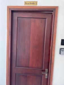a wooden door with a sign above it at Beachside home in Phú Quốc +1 photo