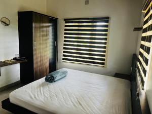 a bedroom with a large bed with a window at Hidden Serene in Kalpetta