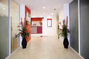 a room with a white wall and a large mirror at Cairns Central Plaza Apartment Hotel in Cairns