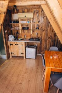a kitchen with wooden cabinets and a table and chairs at Mountain View 2 in Tjentište