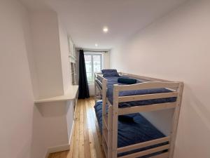 two bunk beds in a room with a hallway at Maison au cœur d’Orgelet in Orgelet
