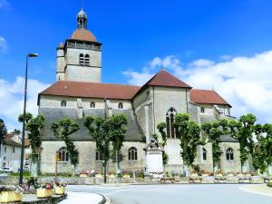an old church with a tower on top of it at Maison au cœur d’Orgelet in Orgelet
