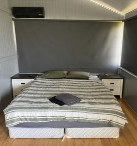a bedroom with a large bed with two night stands at Buchan Street, Accommodation in East Trinity +4 photos