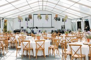 a set up for a wedding reception with tables and chairs at Susimetsa in Laadi