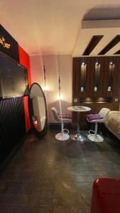 a room with a mirror and two tables and a bed at Luxury KIA Room B in Richmond Hill