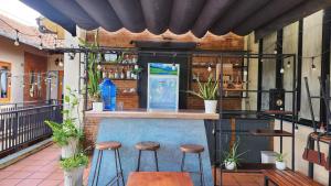 a bar with stools in front of a restaurant at Sun Nova Home Phu Quoc in Phú Quốc