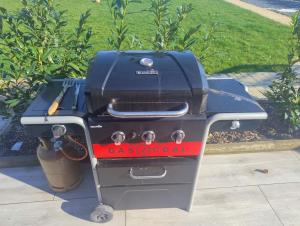 a gas grill sitting on top of a sidewalk at Zen House - Shopping at 3 min in Marnach