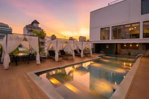 a pool on the roof of a building at Clover Hotel Monivong in Phnom Penh
