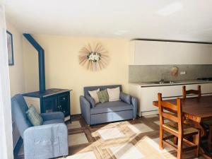 a living room with a couch and a table and a stove at Appartamento Aurora in Orosei