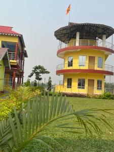 a yellow building with a flag on top of it at North Queen in Lataguri