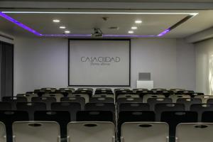 an empty room with a screen and chairs at Hotel Casa Ciudad in Mexico City