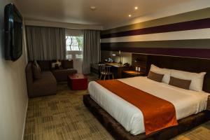 a hotel room with a bed and a desk at Hotel Casa Ciudad in Mexico City