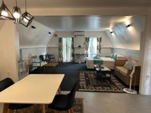 a living room with a couch and a bed at Tia Maria Retreat in Rarotonga