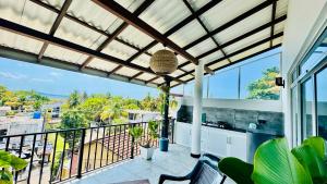 a balcony with a view of the ocean at Reefline Villa in Weligama