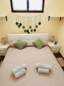 a bedroom with a large bed with two pillows at Appartamento Aurora in Orosei