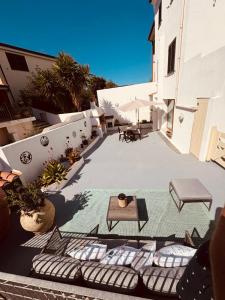 an outdoor patio with lounge chairs and a table at Appartamento Aurora in Orosei