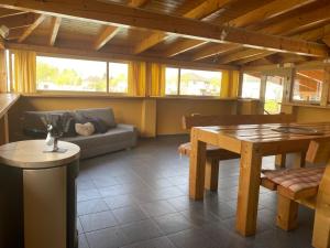 a living room with a table and a couch at MAX apartmán jazero in Trstice