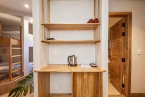 a room with wooden shelves and a tea kettle on a table at La Brise in Ấp Khánh Phước (1)
