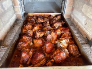a tray filled with chicken and other food items at MAX apartmán jazero in Trstice