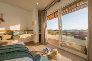 a bedroom with a bed and a large window at La Brise in Ấp Khánh Phước (1)