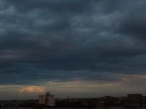 a cloudy sky over a city with buildings at عقار محمد سعيد عجوة in Abū Kabīr