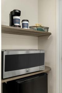 a microwave sitting on top of a shelf at Fairfield Inn & Suites Indianapolis Airport in Indianapolis