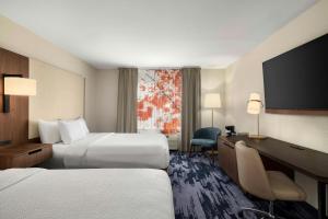 a hotel room with two beds and a flat screen tv at Fairfield Inn & Suites Indianapolis Airport in Indianapolis +22 photos