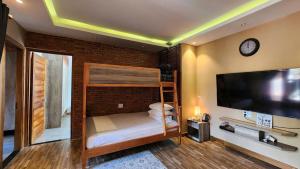 a bedroom with a bunk bed and a flat screen tv at Sun Nova Home Phu Quoc in Phú Quốc