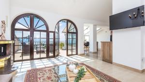 a living room with large windows and a fireplace at Vila Iris - Opatija by Villas Guide in Breza