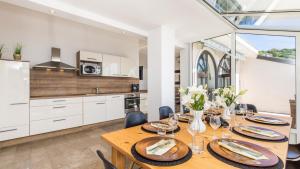 a kitchen and dining room with a table and chairs at Vila Iris - Opatija by Villas Guide in Breza