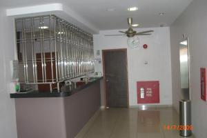 a kitchen with a counter and a ceiling fan at Linkway Hotel in Nusajaya