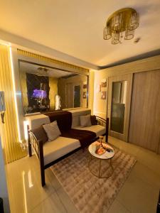 a living room with a couch and a table at Velour Suites in Manila
