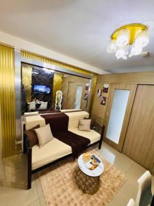 a living room with a couch and a table at Velour Suites in Manila
