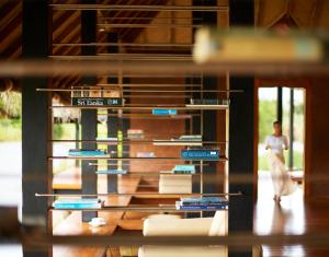 a person walking past a display of books at Jetwing Vil Uyana in Sigiriya