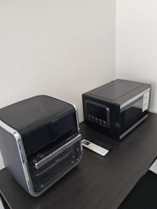 a microwave and a toaster oven on a table at Small Cozy Rest #8 Efficiency in South Bimini