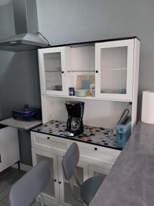 a kitchen with white cabinets and a counter top at Small Cozy Rest #8 Efficiency in South Bimini
