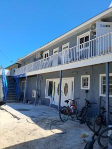 two bikes parked in front of a building at Small Cozy Rest #8 Efficiency in South Bimini