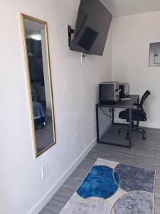 a room with a mirror and a desk with a computer at Small Cozy Rest #8 Efficiency in South Bimini