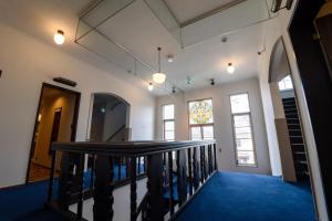 a hallway with a staircase with a stained glass window at T9 Hakodate in Hakodate +60 photos
