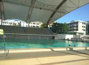 a swimming pool with a cruise ship in the background at Dayang Homestay in Kuantan