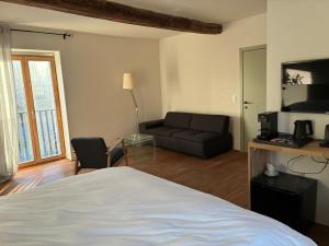 a living room with a bed and a couch at EBURON estate Boutique B&B in Diets-Heur