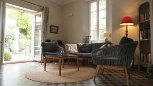 a living room with a couch and a table at La Garance in Bédoin
