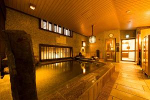 a large swimming pool with a large window at Dormy Inn Premium Wakayama Natural Hot Spring in Wakayama