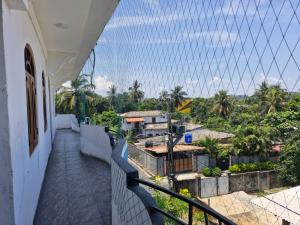 a view from the balcony of a house with a fence at TRINCO VISTARA GUEST House APARTMENT in Trincomalee