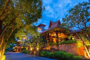 a home in the evening with lights on at Ayrest Hua Hin Hotel in Hua Hin