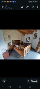 a living room with a large bed and a room with at Villa Amaranta Room and Breakfast in Edolo