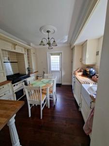 a kitchen with a table and chairs in it at Annasrose cottage in Middlesbrough +16 photos