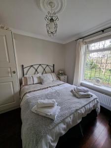 a bedroom with a bed with towels on it at Annasrose cottage in Middlesbrough