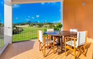 a dining room with a table and chairs and a large window at Sa Font Den Ros in Son Servera